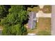 An aerial view of a well-maintained home with mature landscaping, a driveway, and a fully fenced backyard at 1657 6Th Se St, Hickory, NC 28602