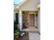 Cozy front porch featuring stone accents, a wooden door, and decorative plants for added charm at 1657 6Th Se St, Hickory, NC 28602