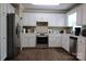 Well-lit kitchen featuring stainless steel appliances, white cabinets and laminate wood flooring at 1657 6Th Se St, Hickory, NC 28602