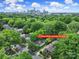 Aerial view of home at 1713 Allen Street, Charlotte, NC 28205, in a tree-lined neighborhood with the city skyline at 1713 Allen St, Charlotte, NC 28205