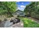 Charming backyard with brick patio, outdoor furniture, and lush landscaping, perfect for relaxing and entertaining at 1713 Allen St, Charlotte, NC 28205