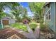 Large backyard featuring a brick fireplace, seating, and a well-maintained lawn at 1713 Allen St, Charlotte, NC 28205