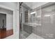 Spa-like bathroom with a glass shower, gray subway tile, and herringbone-patterned floor at 1713 Allen St, Charlotte, NC 28205
