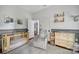 Calming Bedroom with a gray rocking chair, a changing table and a wooden crib at 1713 Allen St, Charlotte, NC 28205
