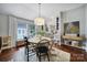 Cozy dining area with a modern chandelier, hardwood floors, and ample natural light at 1713 Allen St, Charlotte, NC 28205