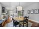 Bright dining area with a modern light fixture, hardwood floors, and open access to the kitchen at 1713 Allen St, Charlotte, NC 28205