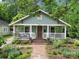 Charming home with a covered front porch, brick pathway, and lush landscaping at 1713 Allen St, Charlotte, NC 28205