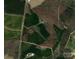 Overhead view of large property featuring farmland, a home, and wooded area all within a defined property line at 1720 Mills Harris Rd, Wingate, NC 28174