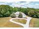 Stunning aerial view of a beautiful home surrounded by lush greenery, circular driveway, showcasing its private and serene setting at 1720 Mills Harris Rd, Wingate, NC 28174