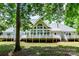 Spacious backyard with a large deck, surrounded by mature trees, offering a private and peaceful outdoor space at 1720 Mills Harris Rd, Wingate, NC 28174