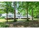Expansive backyard with a white deck, perfect for outdoor relaxation and entertaining, framed by lush trees at 1720 Mills Harris Rd, Wingate, NC 28174