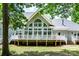 Charming backyard featuring a white deck, complemented by large windows, creating a serene outdoor living experience at 1720 Mills Harris Rd, Wingate, NC 28174