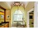 Bright bathroom featuring tub under arched window, custom vanity, and decorative chandelier at 1720 Mills Harris Rd, Wingate, NC 28174