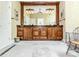 Bathroom with dark wood vanity, granite countertops, and decorative tile floor at 1720 Mills Harris Rd, Wingate, NC 28174