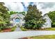 Stately home with stone facade, arched entryway, mature landscaping, and gravel driveway at 1720 Mills Harris Rd, Wingate, NC 28174