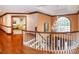 Foyer with curved staircase, hardwood floors, elegant chandelier, and entry to bedroom at 1720 Mills Harris Rd, Wingate, NC 28174