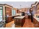 Spacious kitchen boasts custom cabinets, granite countertops, and stainless steel appliances at 1720 Mills Harris Rd, Wingate, NC 28174