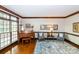 Living room featuring hardwood floors, a piano, and natural light from a large window at 1720 Mills Harris Rd, Wingate, NC 28174