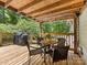 Relax on the back deck with a dining set and grill overlooking the lush, private yard at 17501 Youngblood Rd, Charlotte, NC 28278