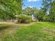 A spacious backyard featuring mature trees and a deck for relaxing and enjoying nature at 17501 Youngblood Rd, Charlotte, NC 28278