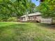 Charming home featuring a spacious backyard with a wooden deck, perfect for outdoor entertaining and relaxing at 17501 Youngblood Rd, Charlotte, NC 28278