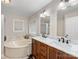 Bathroom with double sink vanity, bathtub, and marble countertops at 17501 Youngblood Rd, Charlotte, NC 28278