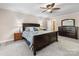 Spacious bedroom with a large bed, dresser, and side tables with lamps at 17501 Youngblood Rd, Charlotte, NC 28278