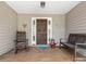 Inviting front porch with wooden bench, rocking chair, and flower pot at 17501 Youngblood Rd, Charlotte, NC 28278