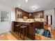 Stylish kitchen featuring wooden cabinets, stone countertops, and breakfast bar at 17501 Youngblood Rd, Charlotte, NC 28278