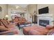 Cozy living room with fireplace, comfortable seating, and views into kitchen at 18669 Vineyard Point Ln, Cornelius, NC 28031