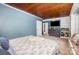Spacious bedroom featuring blue walls, and a walk-in closet, with decorative wood ceiling at 200 Cleveland Ave, Shelby, NC 28150