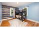 bedroom featuring bunk beds, hardwood floors and blue accent wall at 200 Cleveland Ave, Shelby, NC 28150