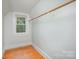 Bright closet space featuring hardwood floors, natural light, and built-in wooden hanging rod at 200 Cleveland Ave, Shelby, NC 28150