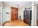 Open kitchen area with stainless steel refrigerator and hardwood floors at 200 Cleveland Ave, Shelby, NC 28150