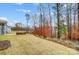 Large backyard with stone firepit and wooded scenery viewed from covered patio at 2011 Cedar Falls Dr # 71, Waxhaw, NC 28173