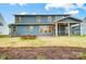 Expansive backyard featuring a stone fire pit and a screened in patio at 2011 Cedar Falls Dr # 71, Waxhaw, NC 28173