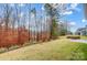 Grassy backyard featuring a stone fire pit and view of autumn foliage at 2011 Cedar Falls Dr # 71, Waxhaw, NC 28173