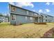 Large backyard showcasing lush grass, stone firepit, and outdoor patio at 2011 Cedar Falls Dr # 71, Waxhaw, NC 28173