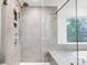 Elegant bathroom with a glass shower, featuring gray tile and modern shower fixtures at 2011 Cedar Falls Dr # 71, Waxhaw, NC 28173