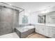 A modern bathroom featuring gray tile, a glass shower, and a soaking tub at 2011 Cedar Falls Dr # 71, Waxhaw, NC 28173