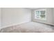 Bright, carpeted bedroom featuring a window with natural light and neutral paint color at 2011 Cedar Falls Dr # 71, Waxhaw, NC 28173