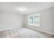 Neutral bedroom filled with light from large window and plush carpet flooring at 2011 Cedar Falls Dr # 71, Waxhaw, NC 28173