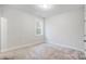 Bright bedroom featuring neutral carpeting, a window, and crisp white trim at 2011 Cedar Falls Dr # 71, Waxhaw, NC 28173