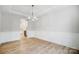 Spacious dining room with hardwood floors, decorative lighting, and wainscoting at 2011 Cedar Falls Dr # 71, Waxhaw, NC 28173