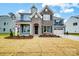 Charming two-story home featuring stone accents, a two-car garage, and beautifully landscaped front yard at 2011 Cedar Falls Dr # 71, Waxhaw, NC 28173