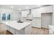 Modern kitchen with white cabinets, stainless steel appliances, and a large center island at 2011 Cedar Falls Dr # 71, Waxhaw, NC 28173