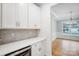 Butler's pantry featuring white cabinetry, quartz counters, tile backsplash, and a wine cooler at 2011 Cedar Falls Dr # 71, Waxhaw, NC 28173