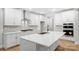Modern kitchen with white cabinets, a large island, stainless steel appliances, and subway tile backsplash at 2011 Cedar Falls Dr # 71, Waxhaw, NC 28173