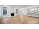 Open-concept space with a fireplace and hardwood floors seamlessly connects the living area and kitchen at 2011 Cedar Falls Dr # 71, Waxhaw, NC 28173