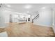 Open-concept living space with hardwood floors, a kitchen island, and staircase at 2011 Cedar Falls Dr # 71, Waxhaw, NC 28173